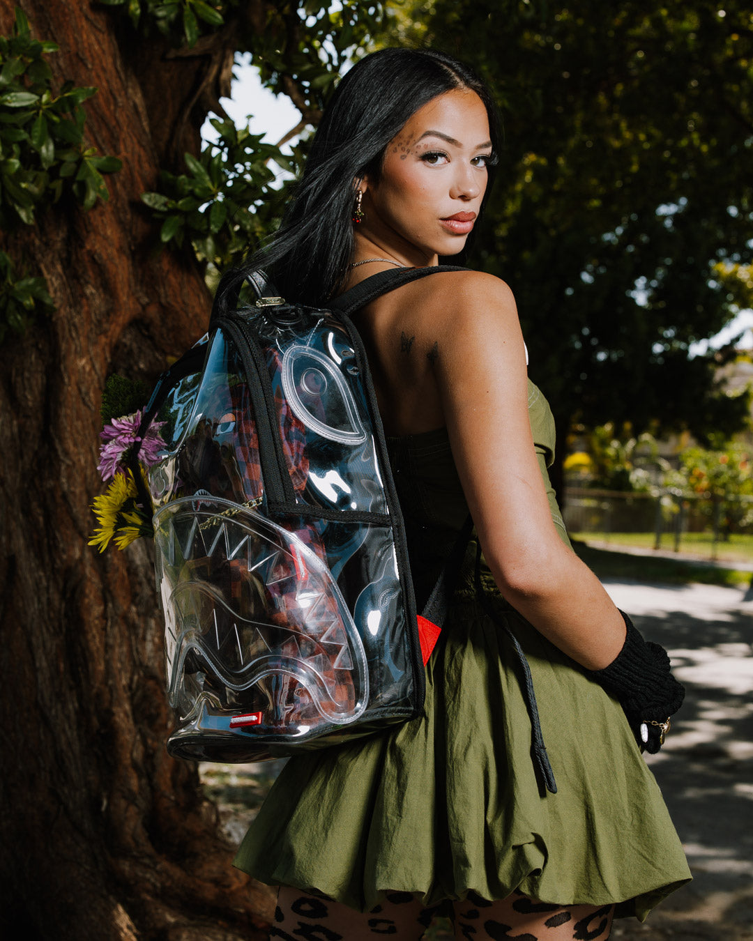 Front view of the clear sprayground backpack with shark design and removable bear accessory