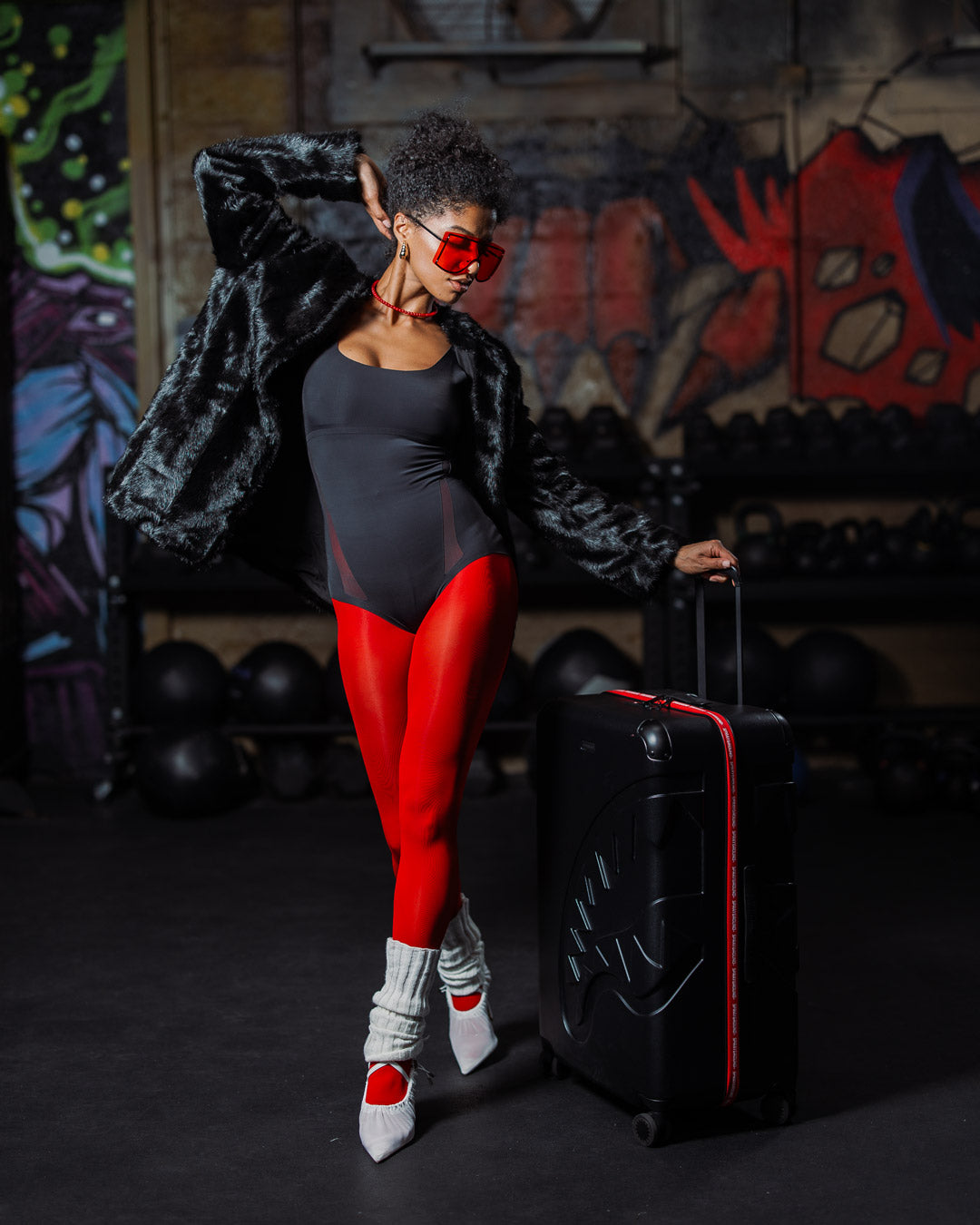Sprayground Hero Sharkitecture full-size luggage being maneuvered with its 4 dual spinning wheels