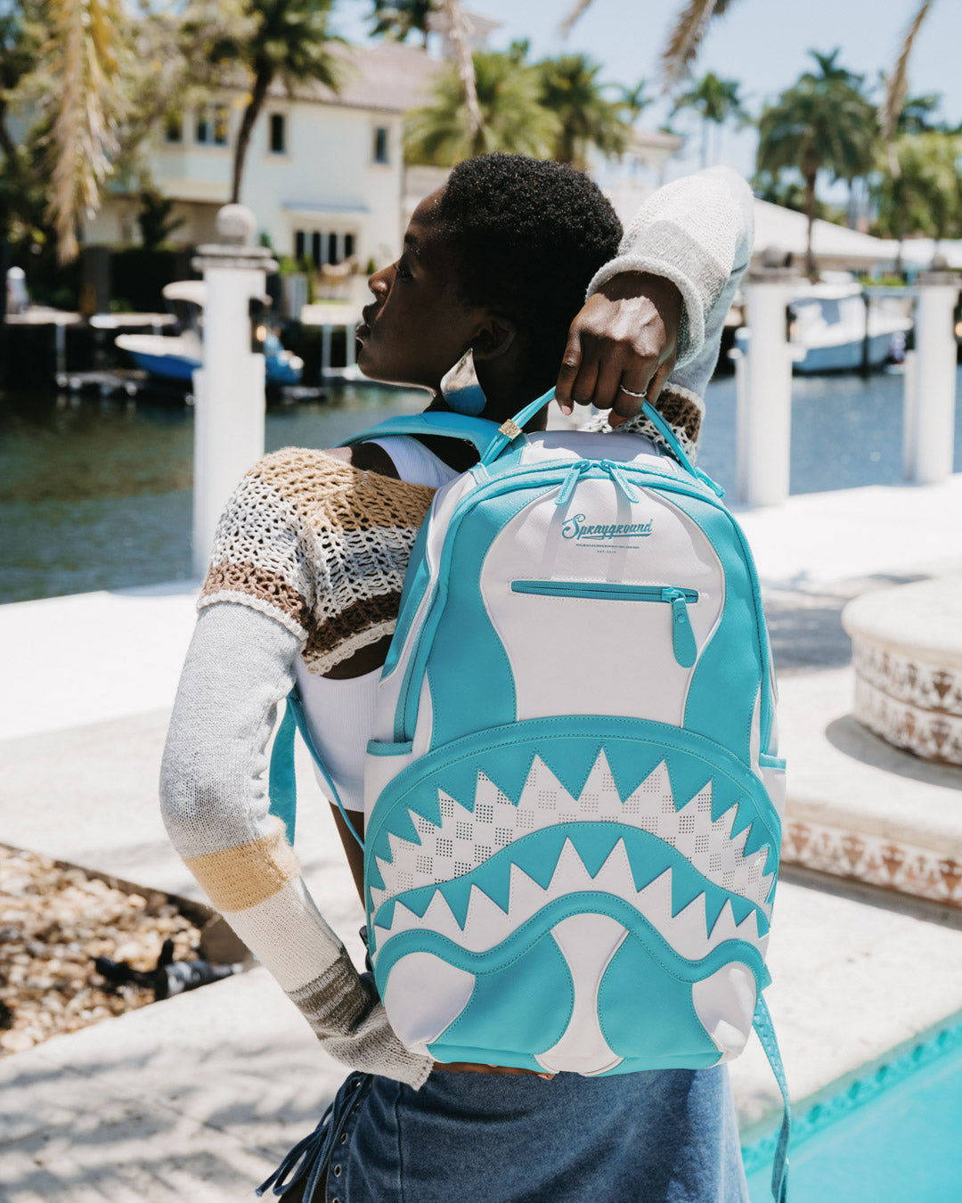 Backpack worn by a model, showcasing its ergonomic design for urban travel.