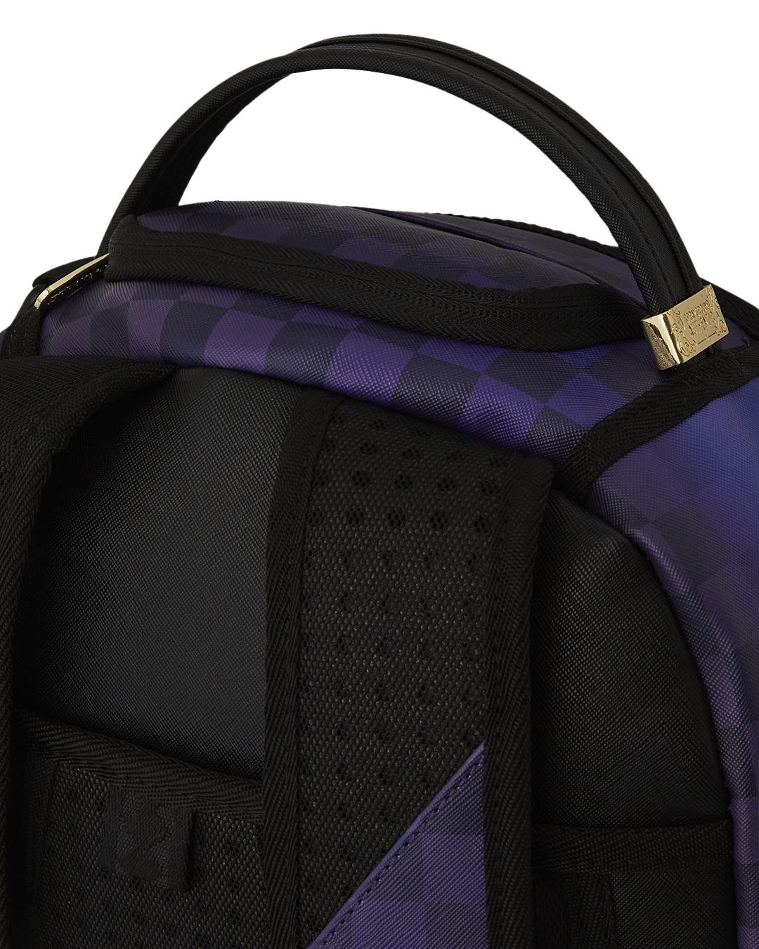 Close-up of faux leather backpack showing gold zippers and badge detail