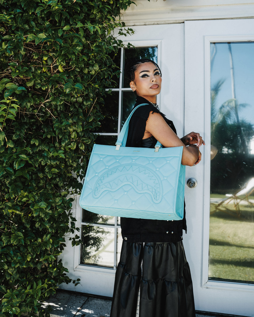 Close-up of the quilted texture and embossed details on the designer tote bag