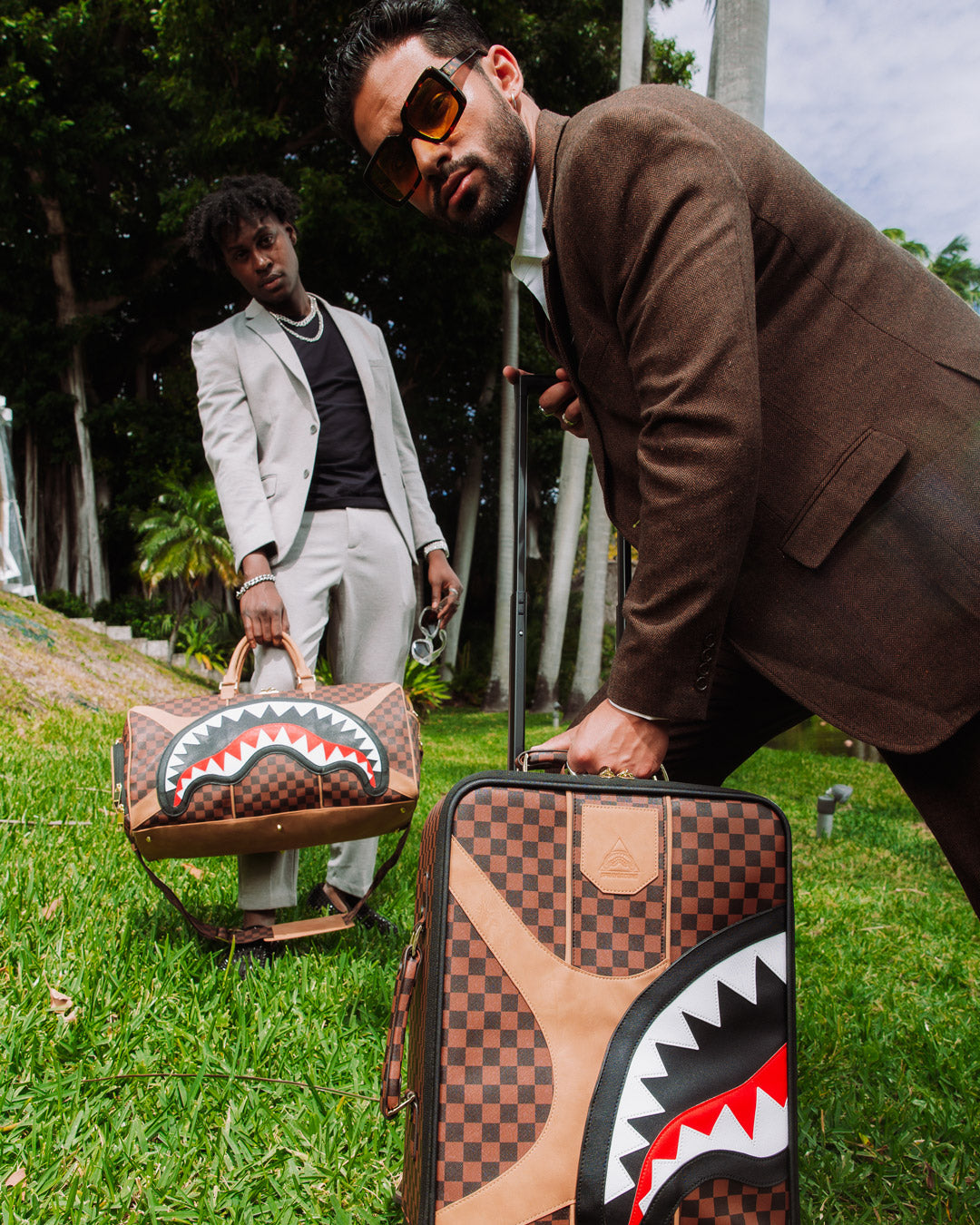 Close-up of Hennyville duffle bags zippered sneaker pocket and gold hardware.