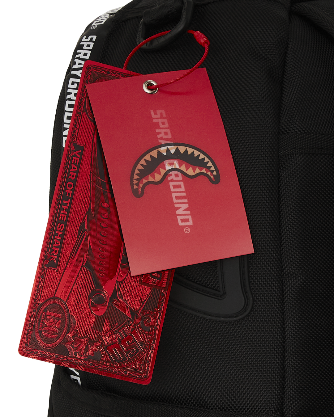Sprayground Hero White Tape DLXR Backpack interior view, featuring its separate velour laptop compartment and mesh organizer pocket.
