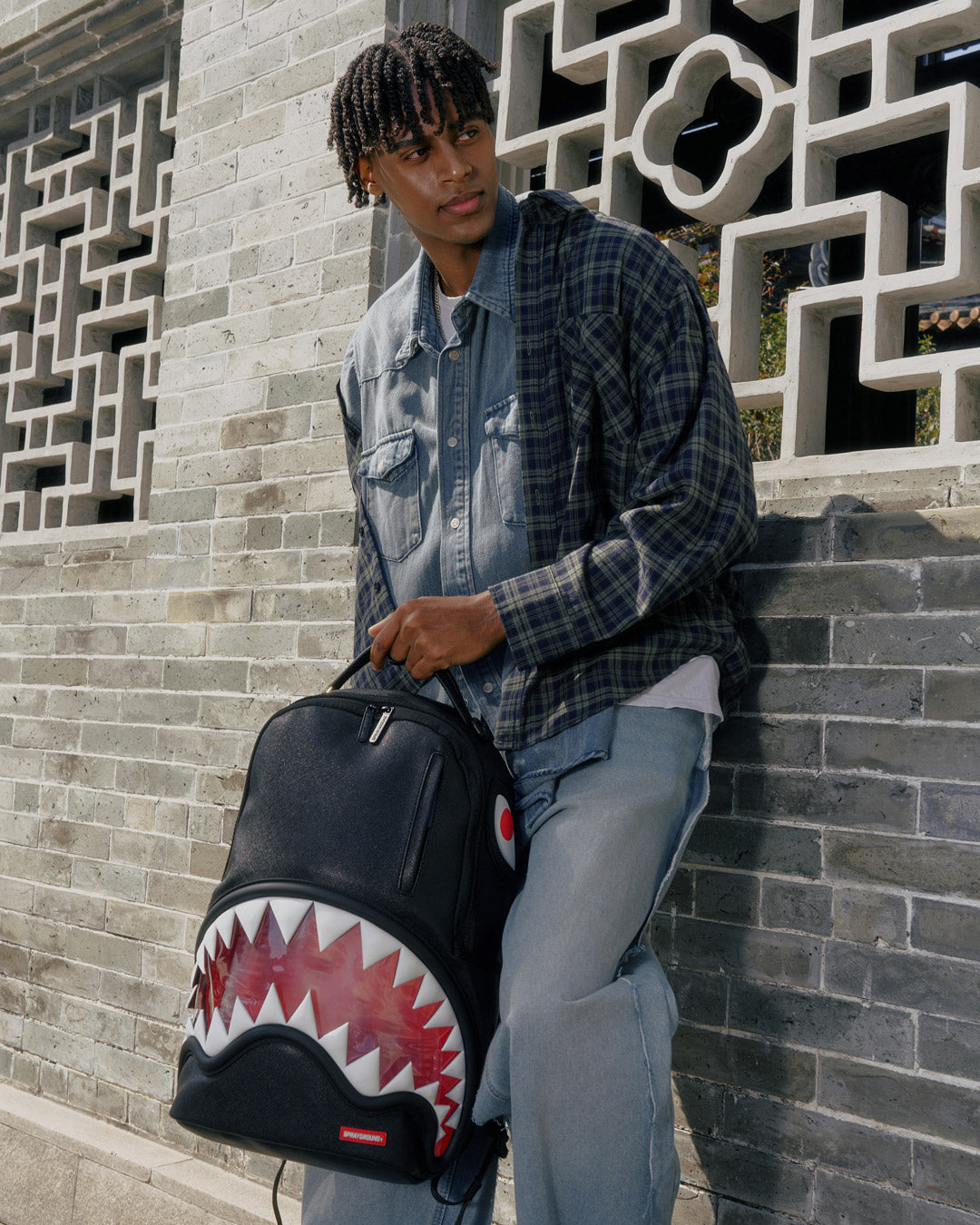 Front view of clear backpack with shark bite design and gold zippers