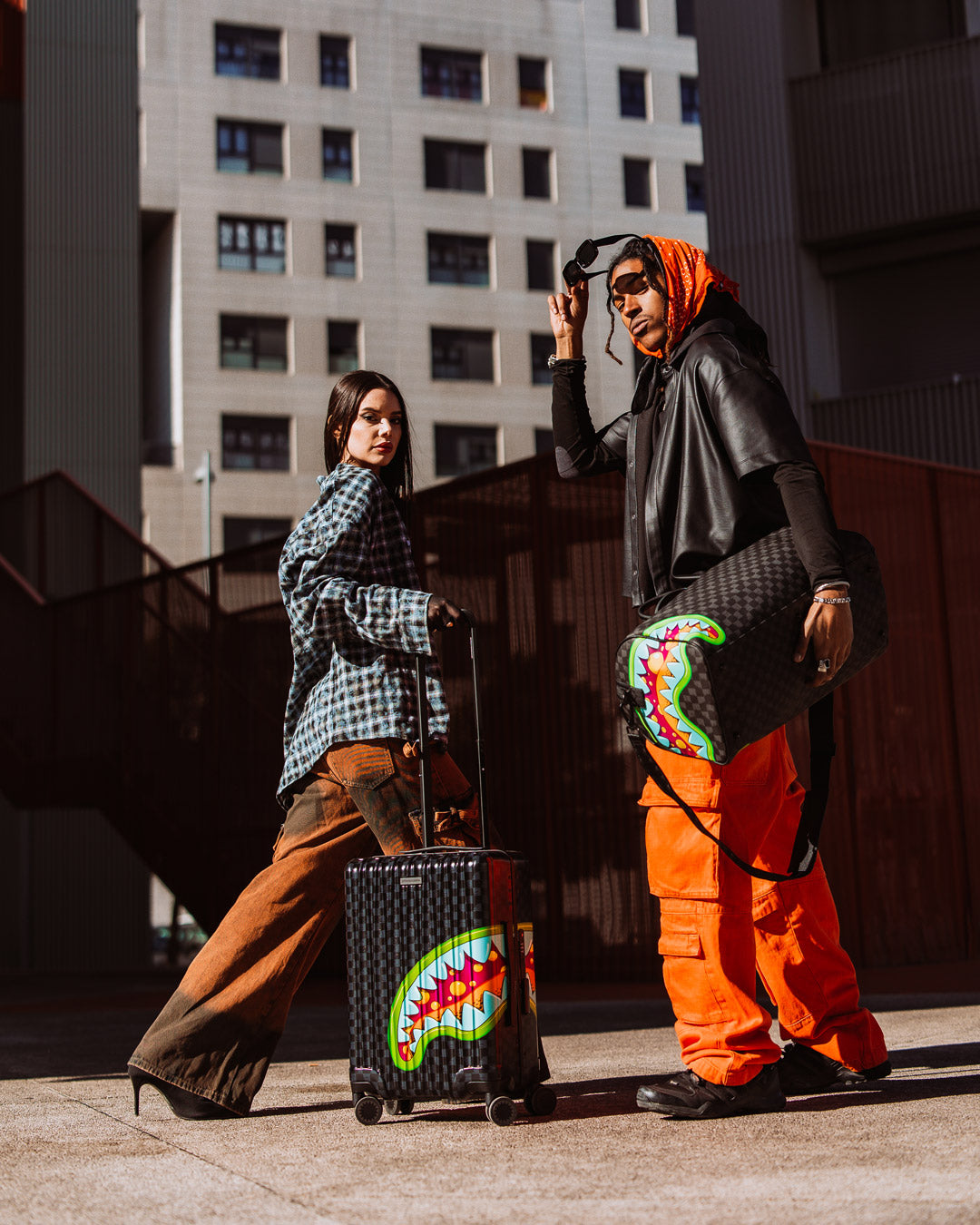 Close-up of Sprayground slime duffle bag’s gold zippers and faux leather texture