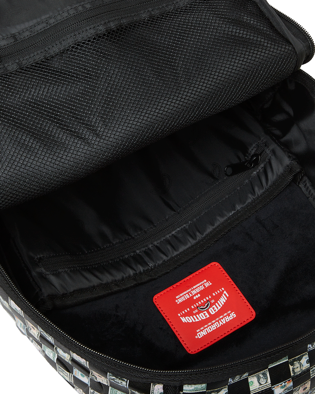 Close-up of the backpacks interior, highlighting the separate velour laptop compartment and mesh organizer pocket.