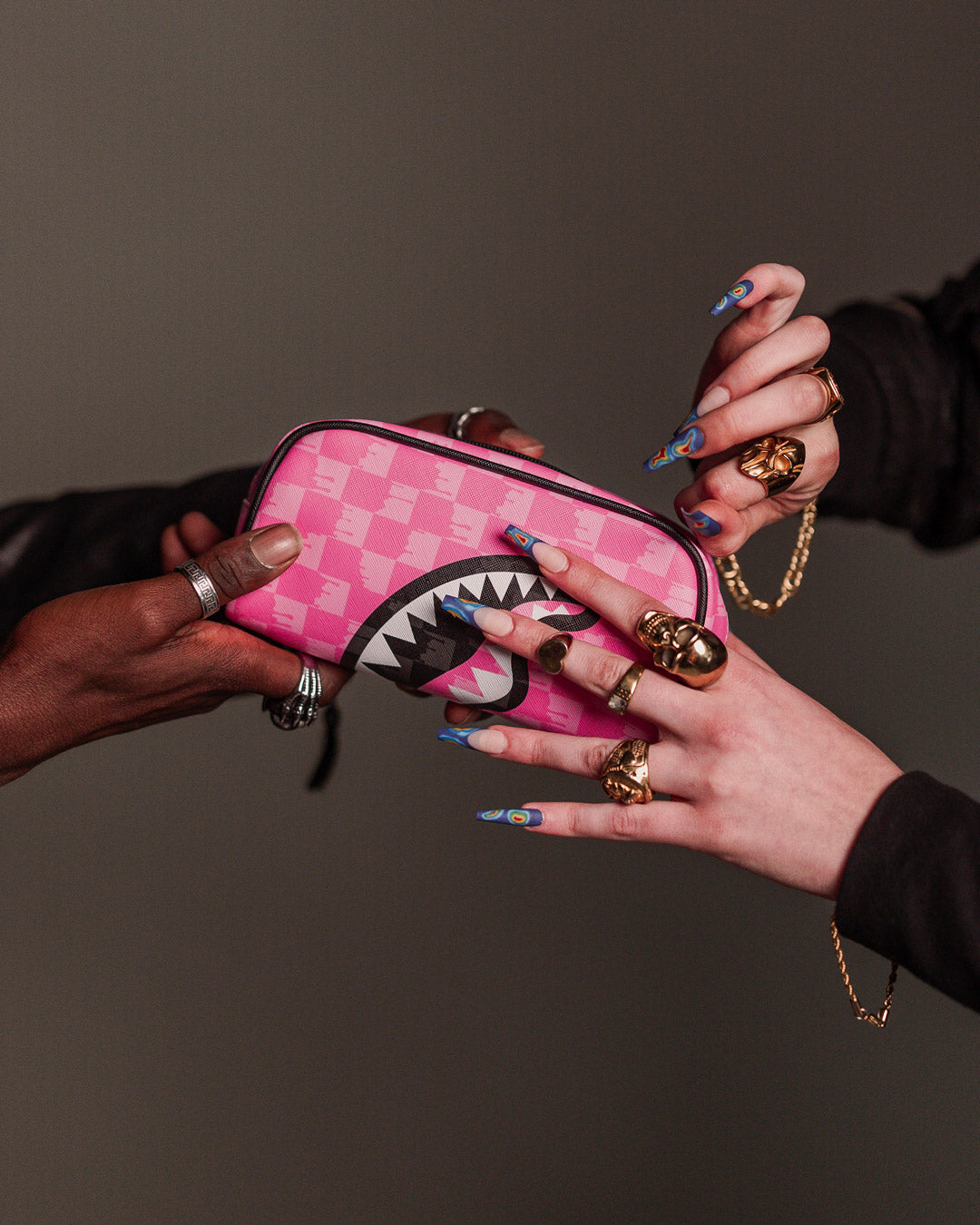 Pink Paradise PVC pouch held in hand for size reference
