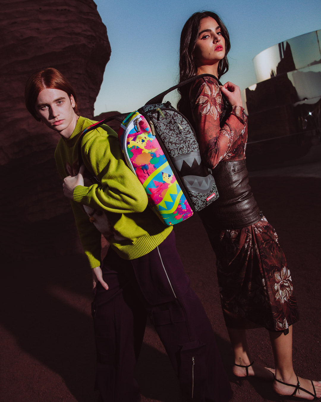 Two separated mini backpacks laid flat, highlighting interior mesh pockets