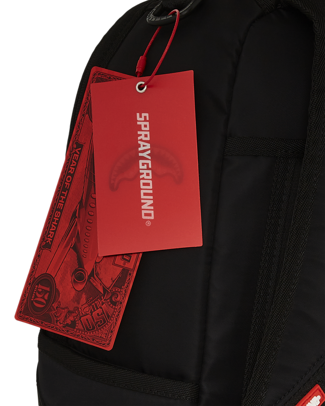 Sprayground Shark Mouth Neon Venom Backpack being used for travel, connected to a carry-on luggage