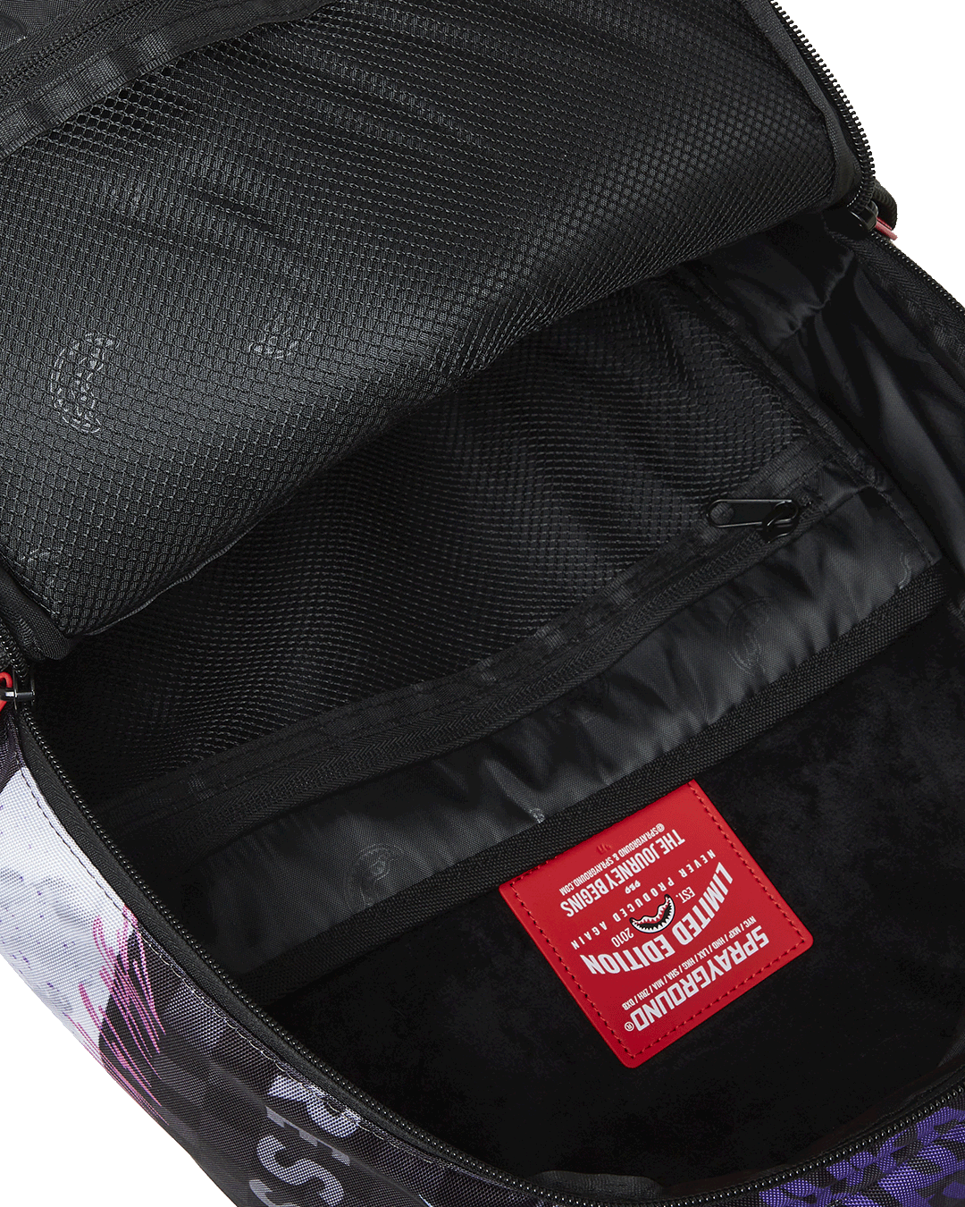 Interior shot showing the laptop compartment and mesh organizer pocket