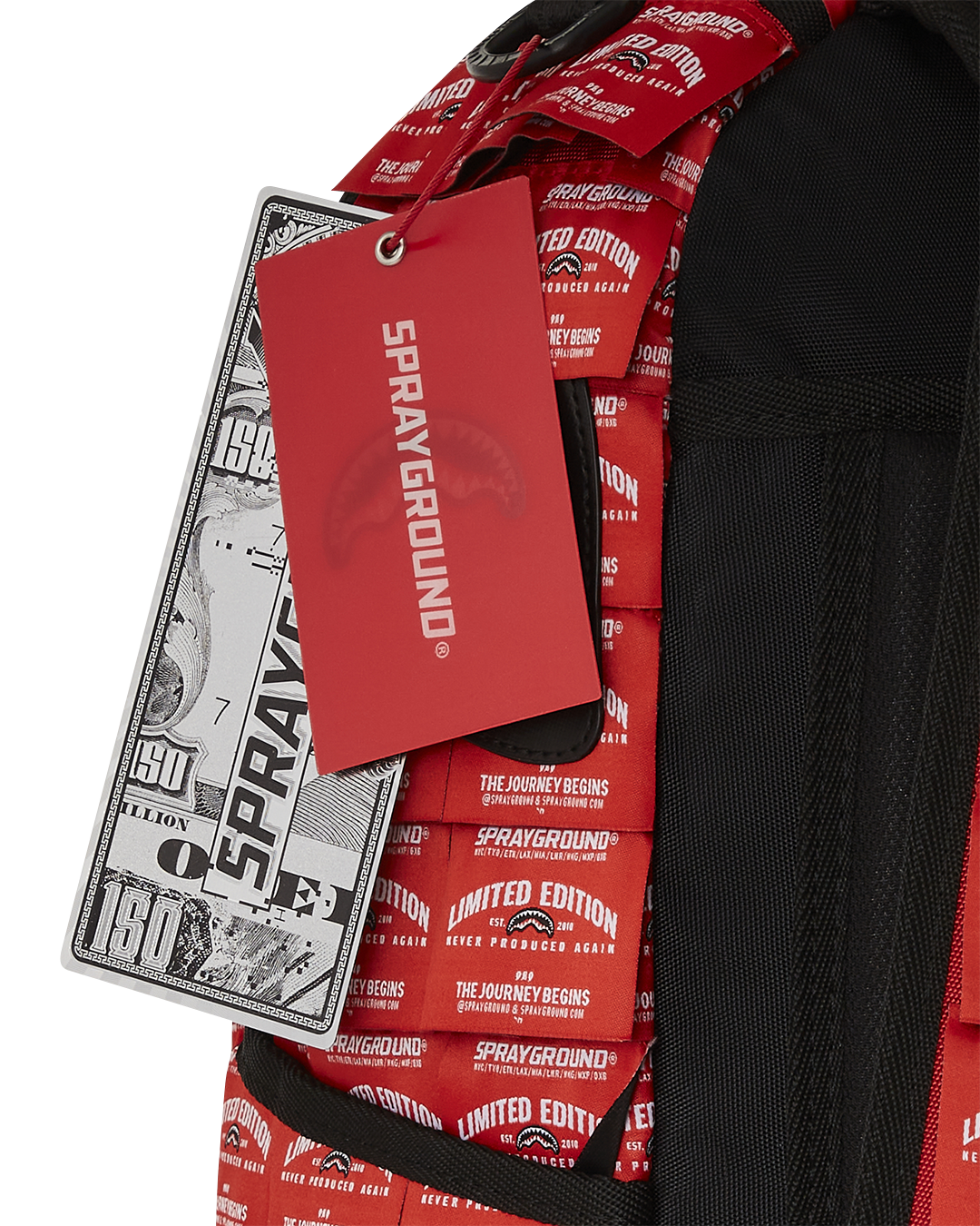 Front view of shark backpack with fringe labels and gold zippers.