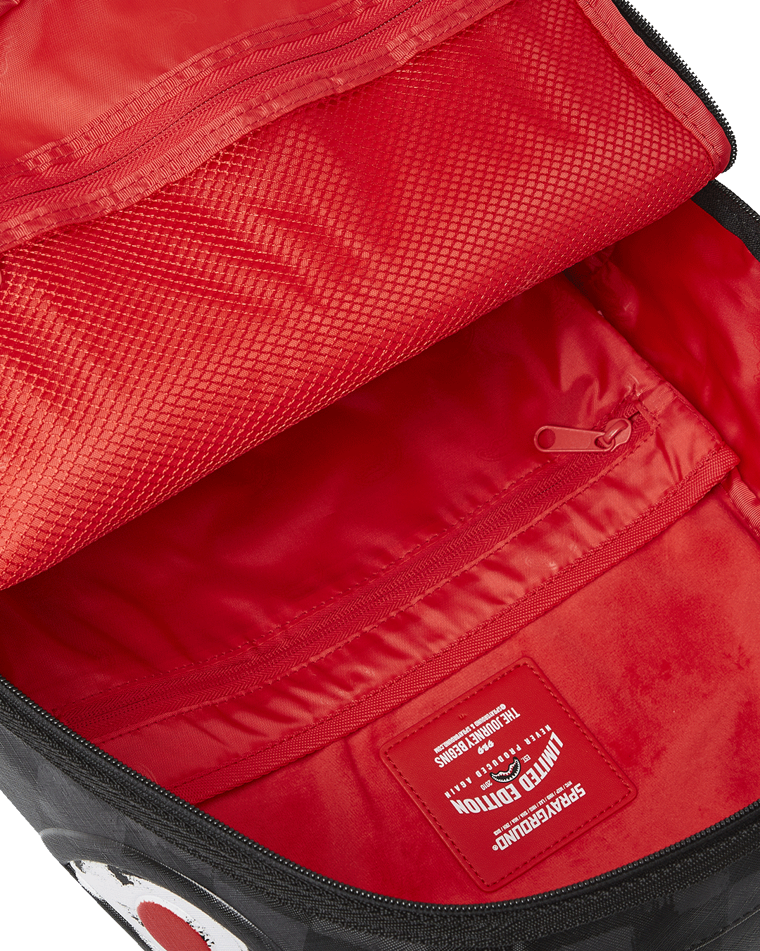 Interior shot showing the velour laptop compartment and mesh organizer pocket
