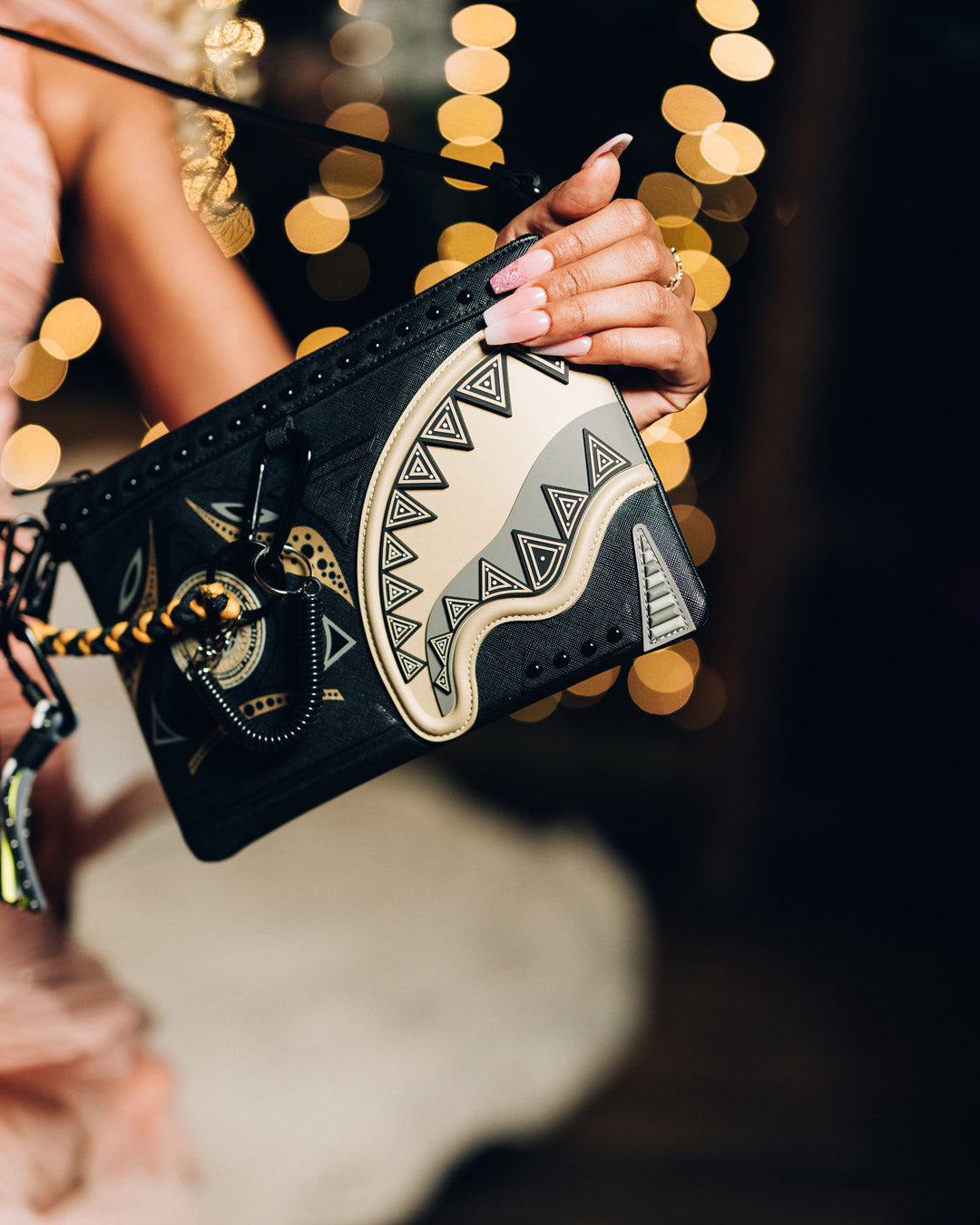 Gold designer clutch held in hand, showcasing metallic finish