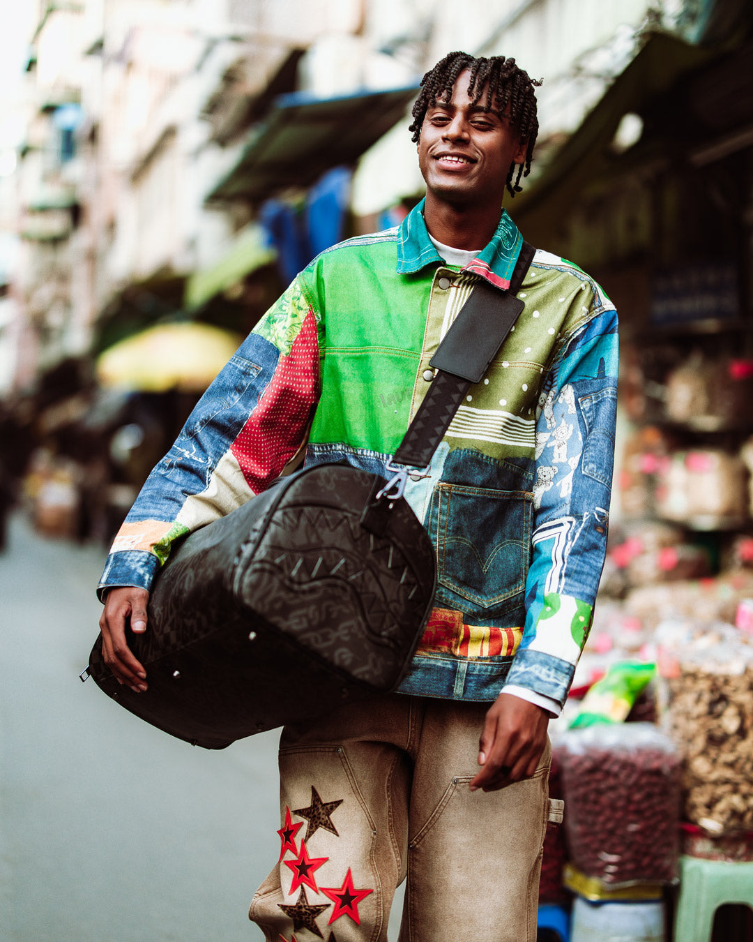 Emperor faux leather duffle bag held by traveler in airport setting