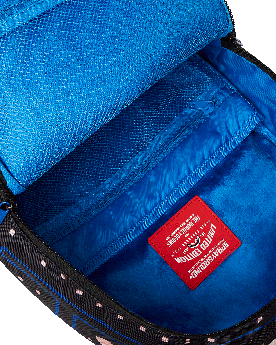 Close-up of ghost zipper puller and gold hardware on laptop bag