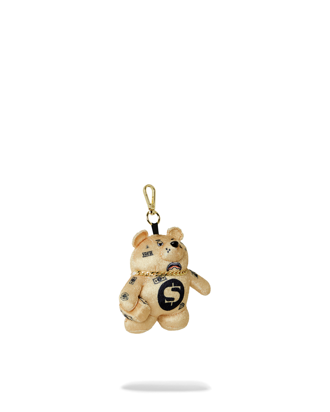A person holding the teddy bear keychain, showing how it can be used as a bag charm.
