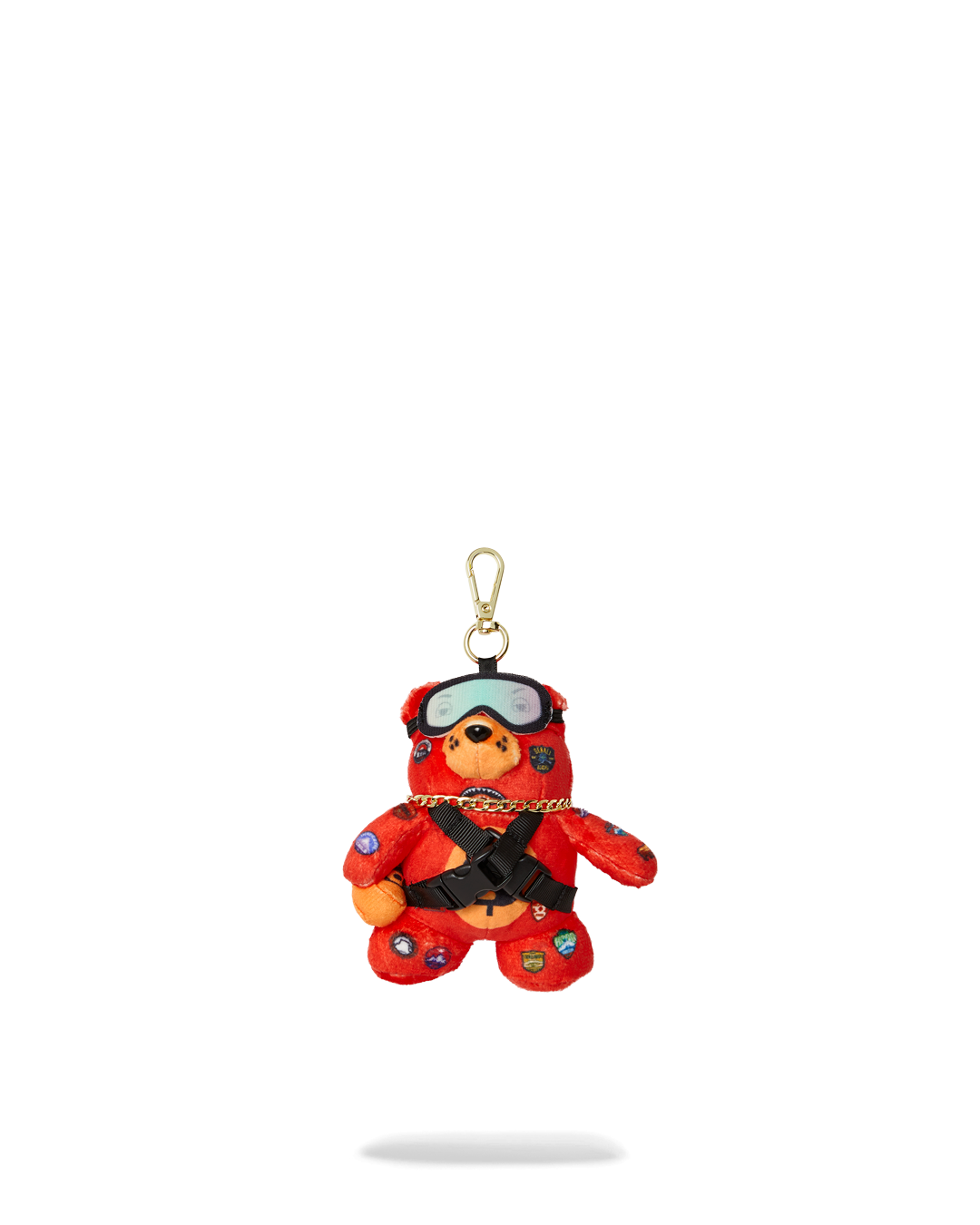 Close-up of plush bear keychain with tiny goggles and hat, best for travel lovers