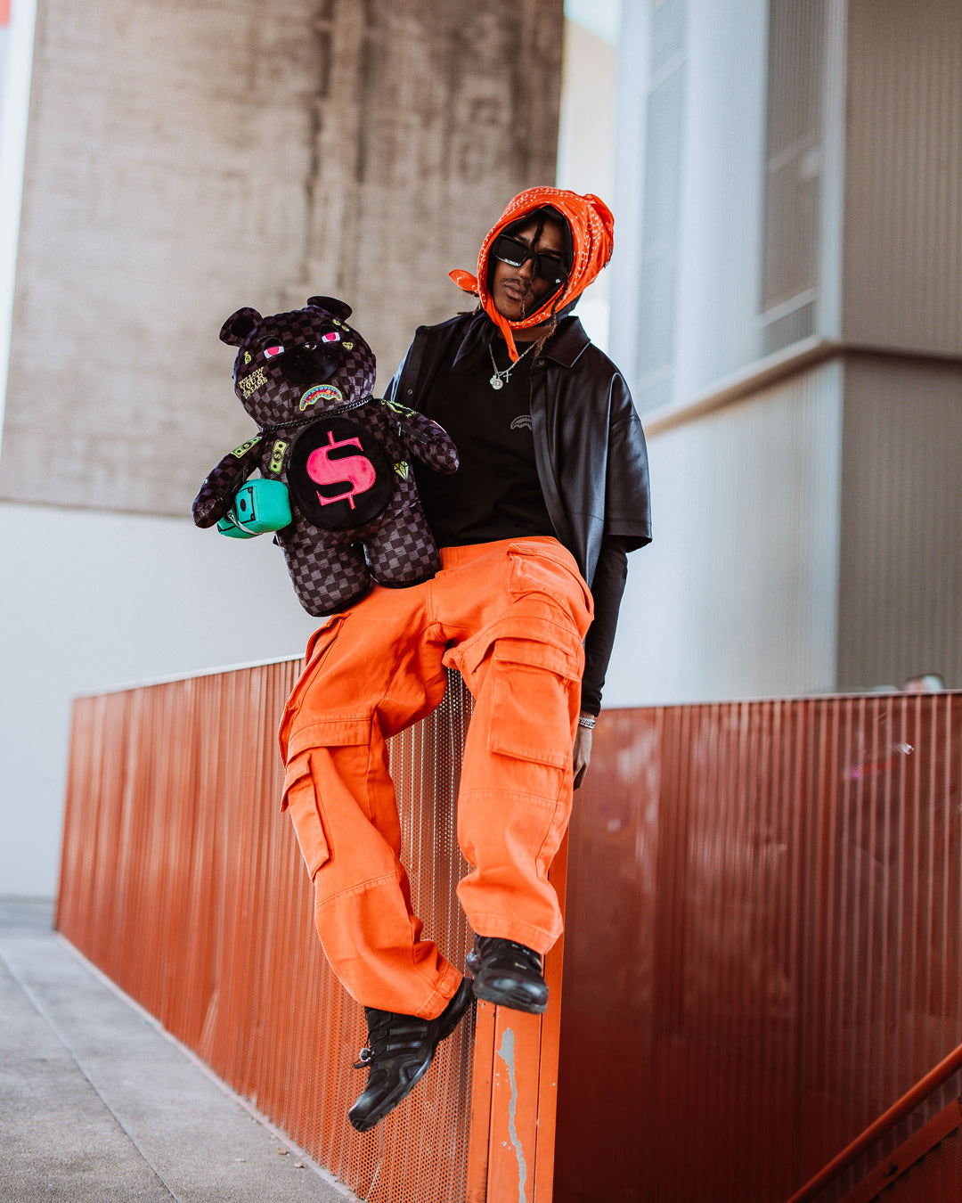 Side view highlighting the zippered arm pockets on the sprayground backpack money bear.