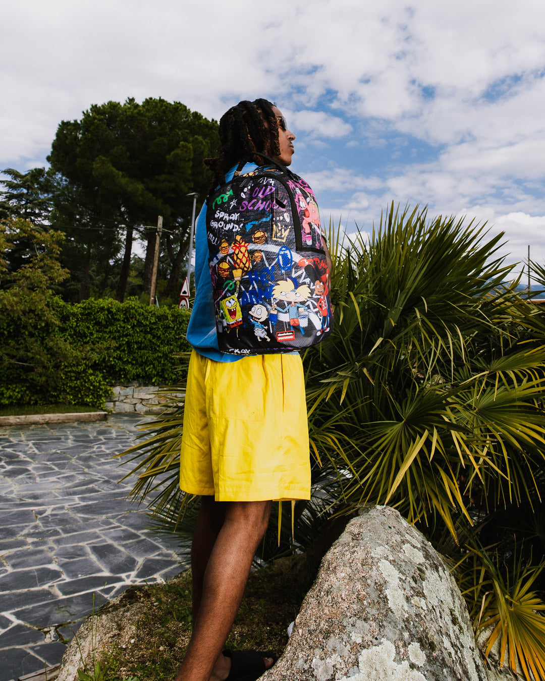 Front view of the Limited Edition pink Sprayground backpack showcasing its vibrant design and gold zippers.