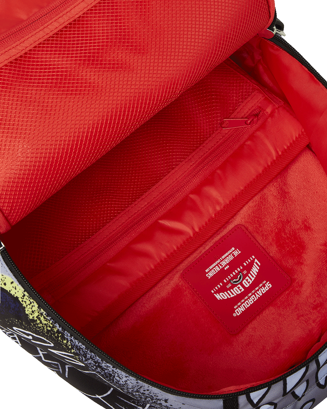 Daybreak Luxe backpack with front zipper pocket and side pockets.