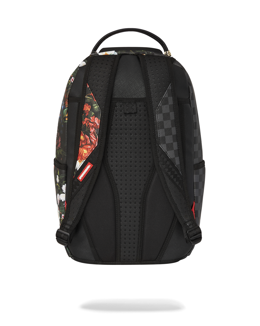 Sprayground faux leather backpack worn by a woman in an urban setting