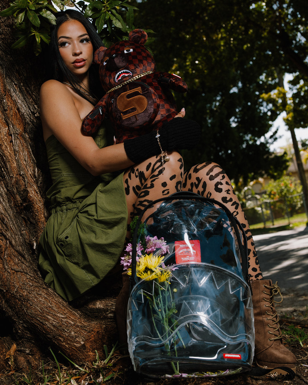 Front view of the clear sprayground backpack with shark design and removable bear accessory
