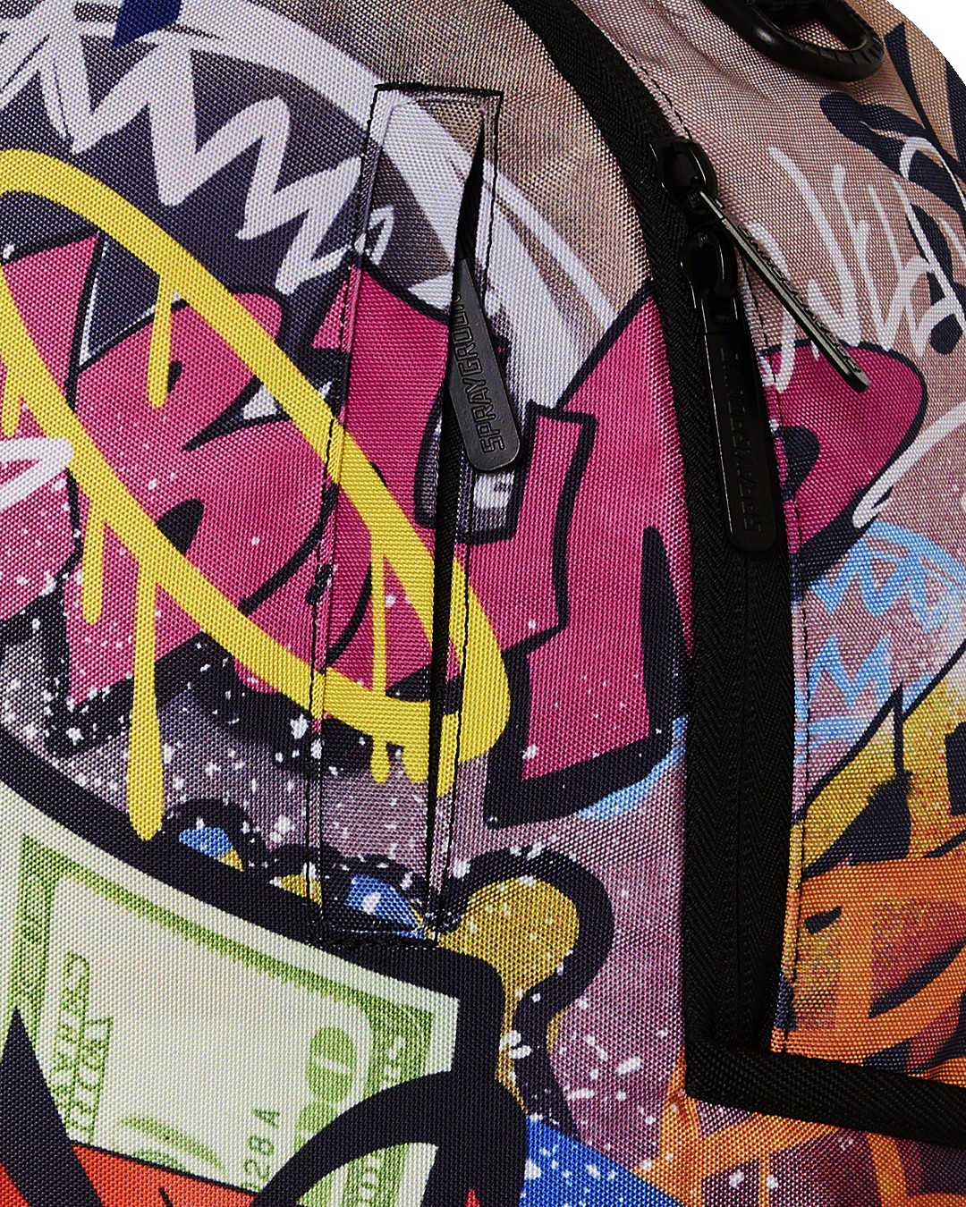 Close-up of the backpacks front zipper pocket with gold hardware