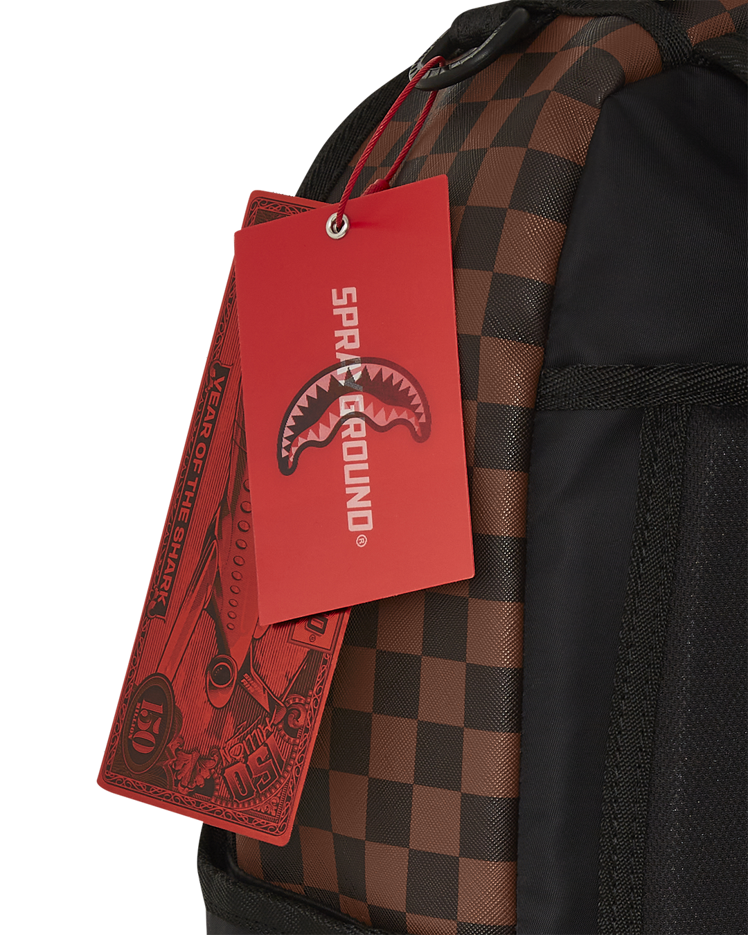 Maison Check backpack worn over shoulder, showcasing sharkmouth detail against city backdrop