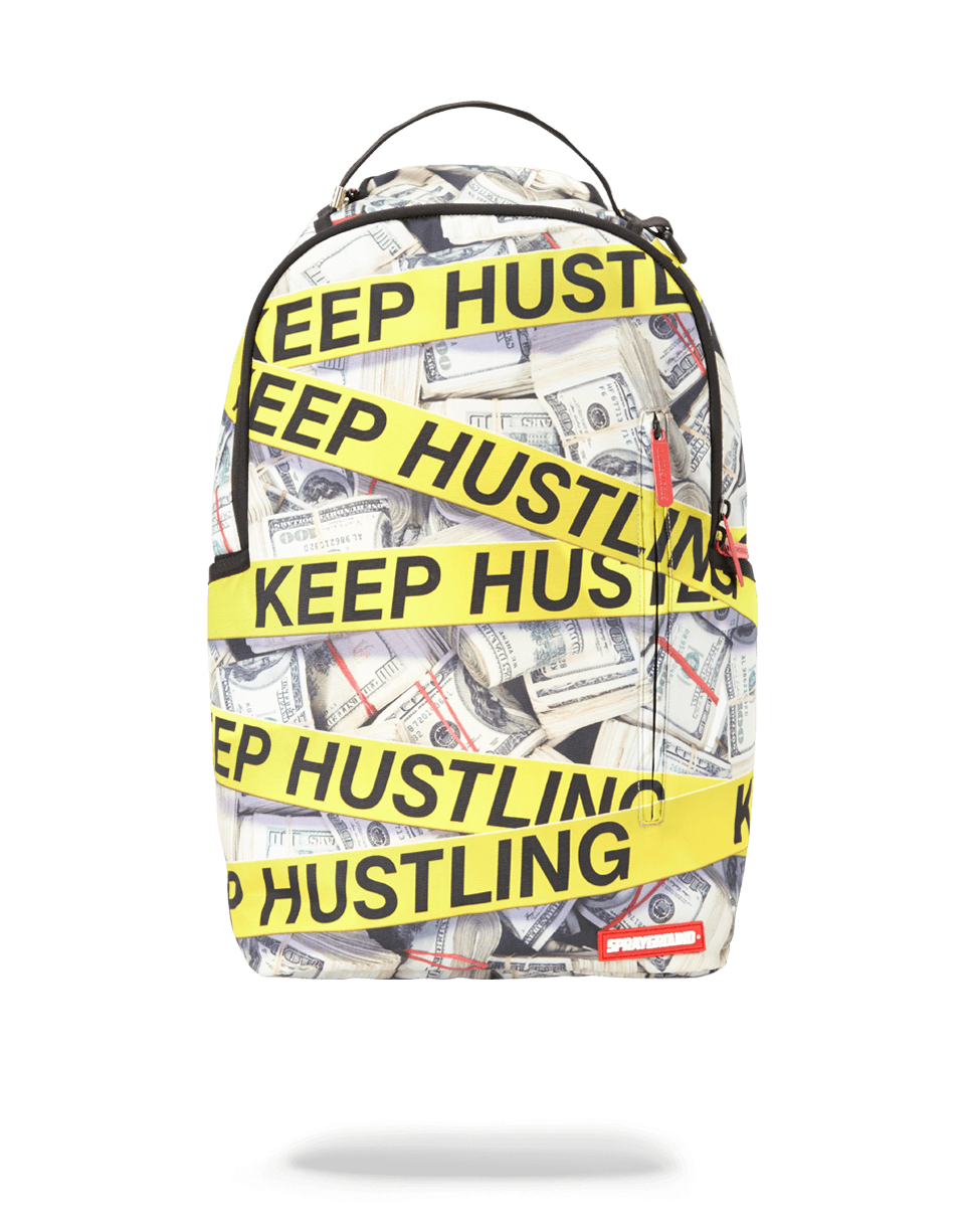 Women carrying the Sprayground Hustle backpack in a city setting