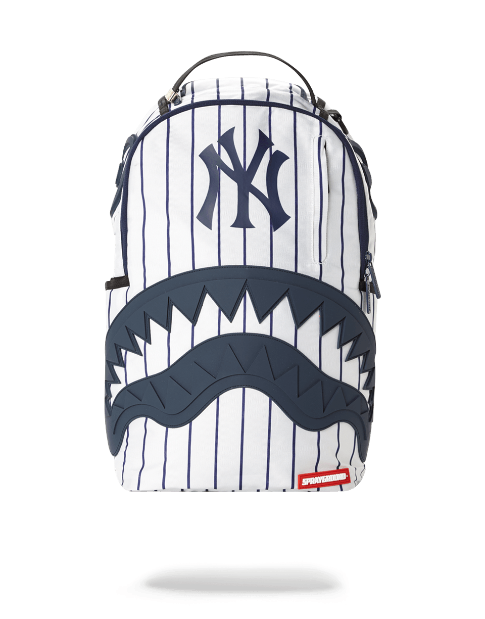 NY Yankees backpack worn over shoulders with city skyline backdrop