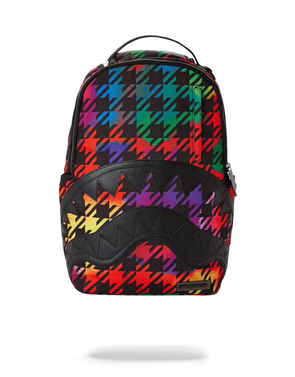 The London Sprayground backpack worn over one shoulder, showcasing its sleek design and laptop compartment.