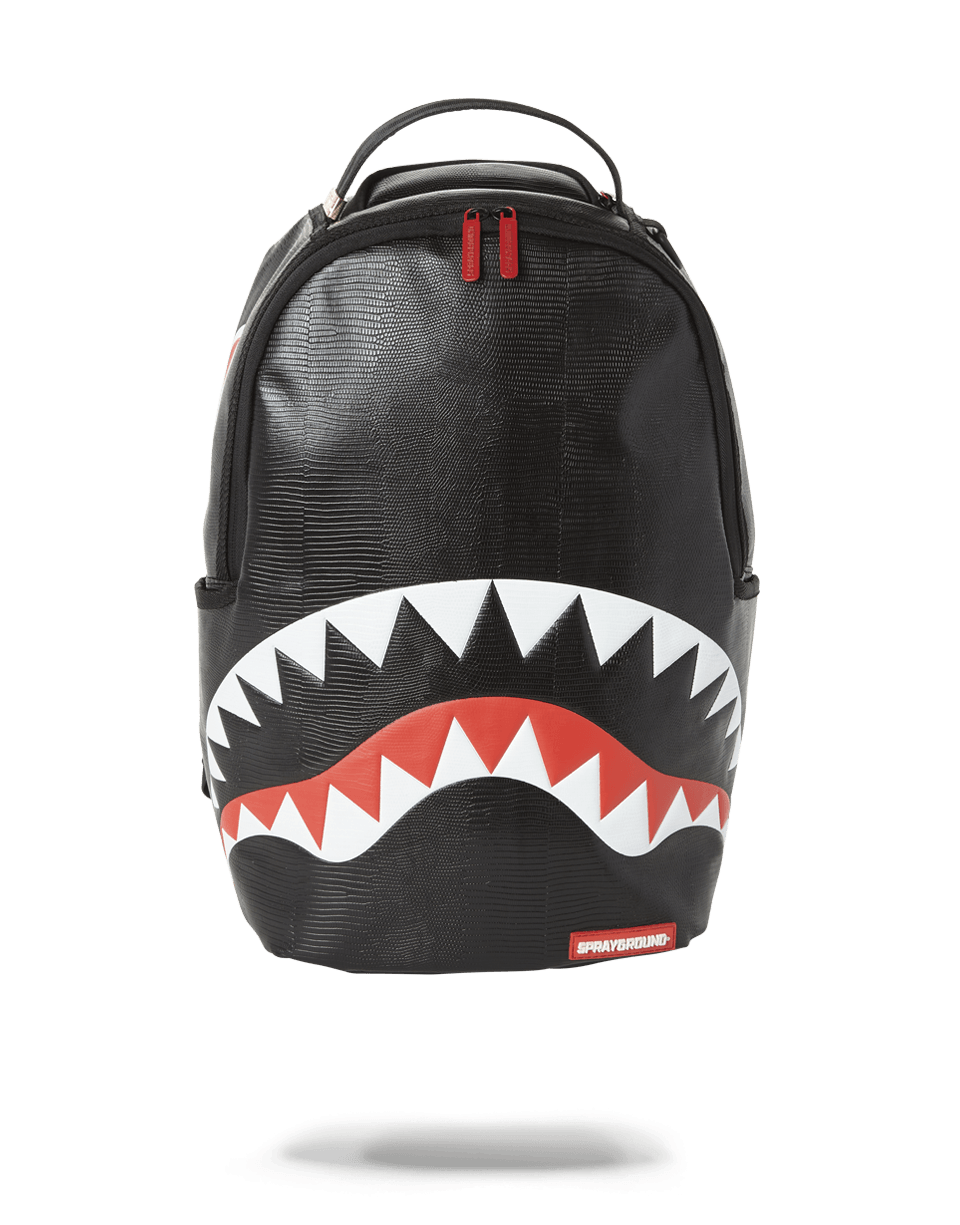 Black reptile-pattern laptop backpack worn by a professional woman in urban setting