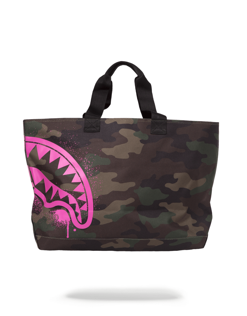 Shark camo tote bag held by handle, showcasing front zipper pocket.