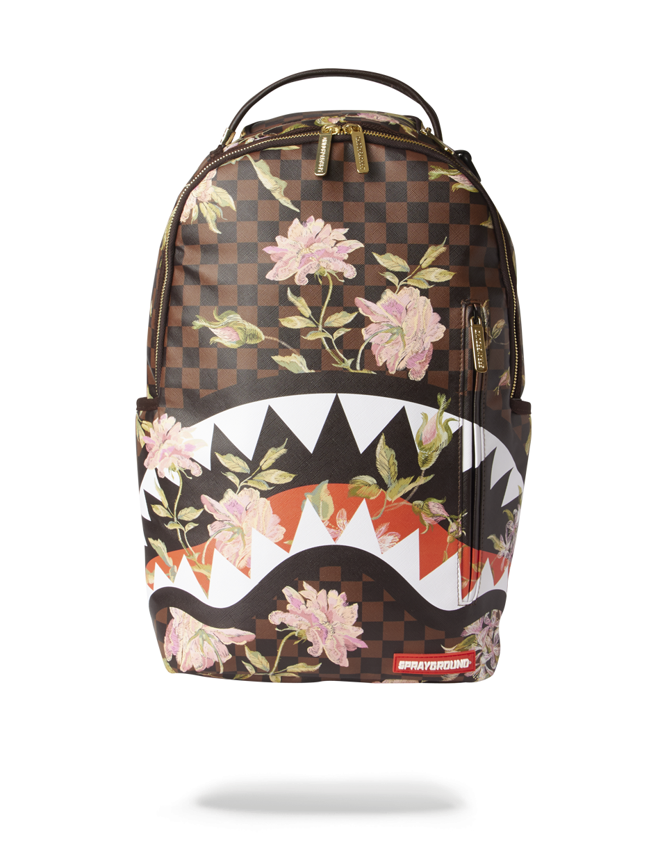 Close-up of Sharkflower DLX vegan leather backpack showing gold zippers and hardware