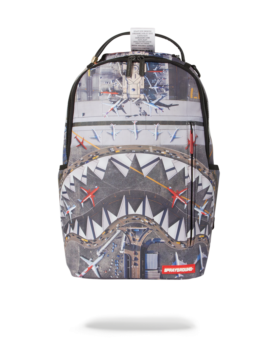Gunmetal vegan leather backpack worn crossbody in airport setting