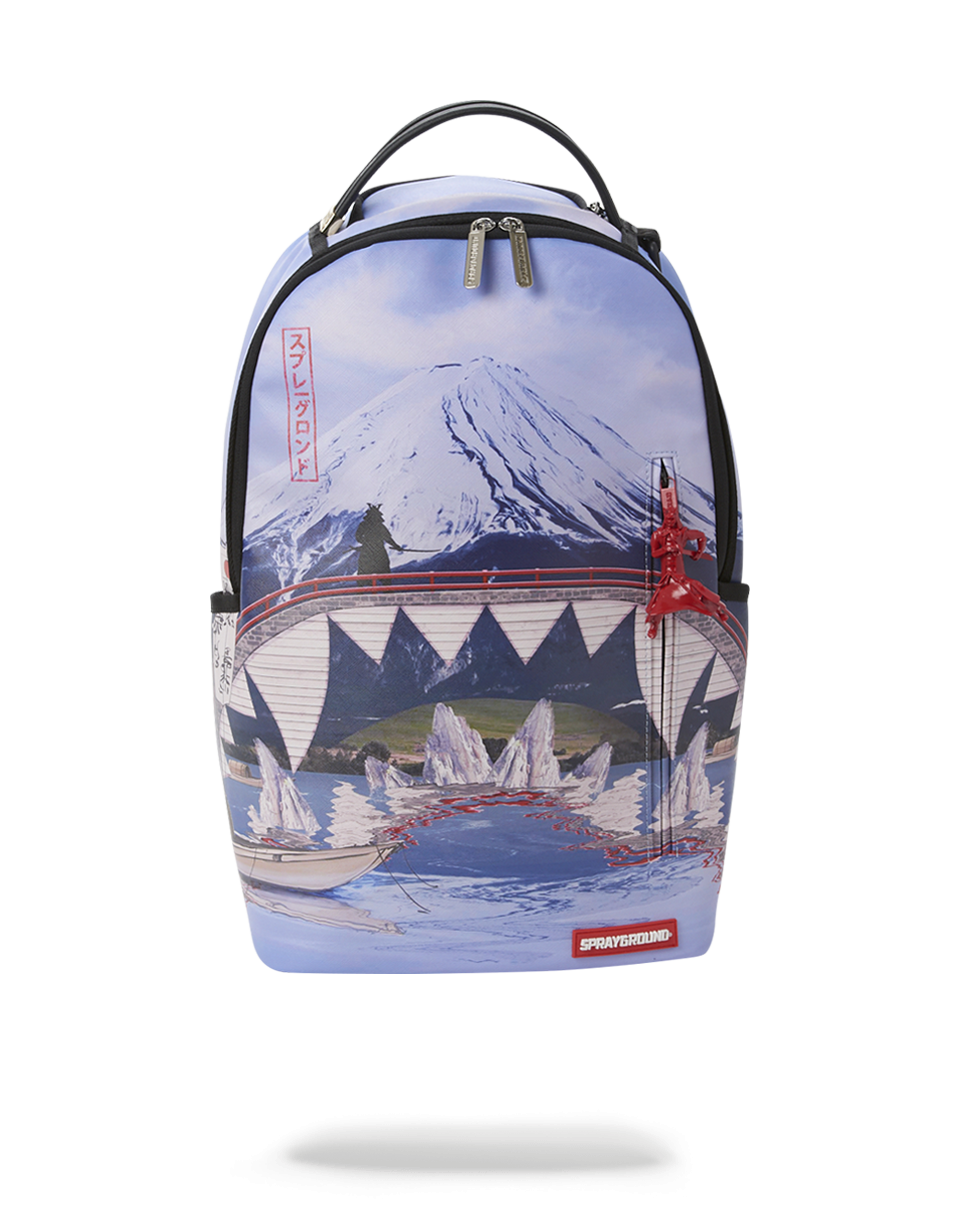 Close-up of Sacred Mountain leather backpack showing zippered compartments and metal hardware