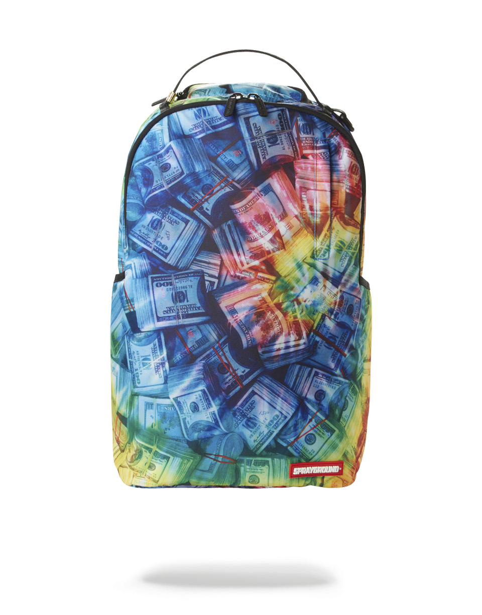 Front view of pink Sprayground backpack with rainbow design against city backdrop