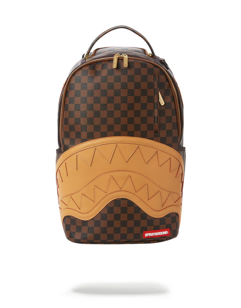 Angled view of the designer backpack showing gold hardware and side pockets