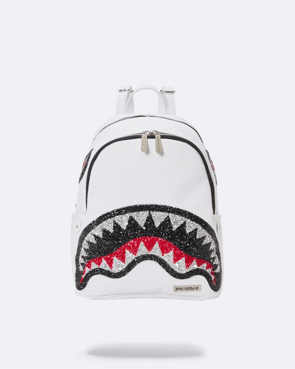 Front view of crystal-embellished white backpack with gold zippers on wooden bench