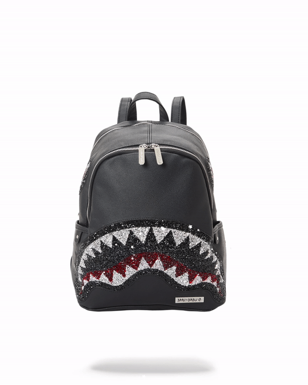 Angled view of black vegan leather backpack with crystal accents on a city rooftop