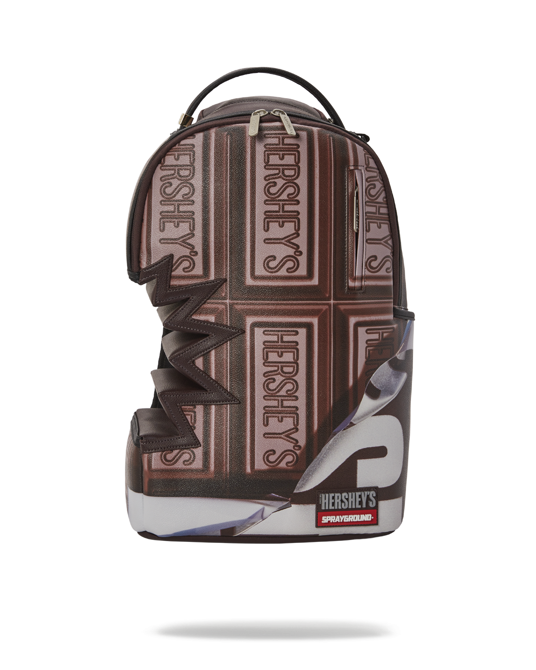 Angled view of the clear sprayground backpack with gold zipper and Hershey’s shark bite graphic