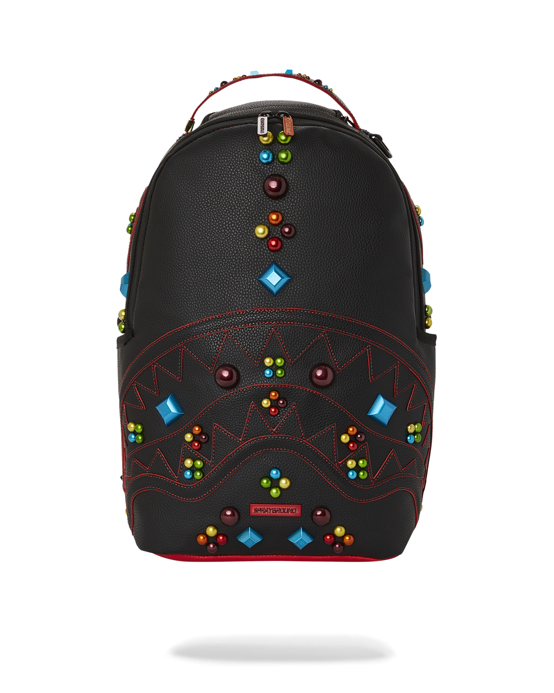 Close-up of DLXV backpack's enamel studs and sharkmouth detailing