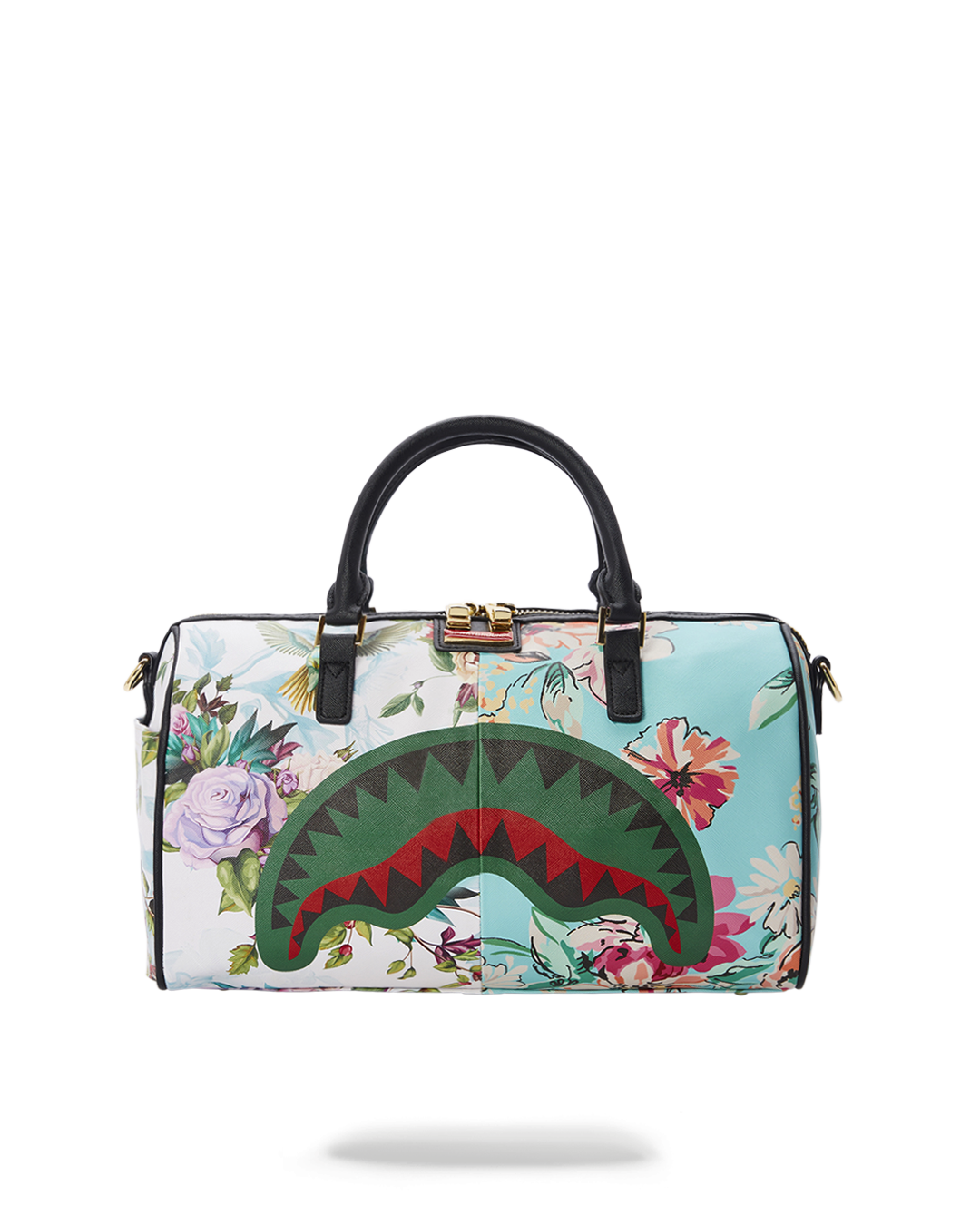 Sanctuary mini duffle bag held by handles, showcasing side pocket and vegan leather texture