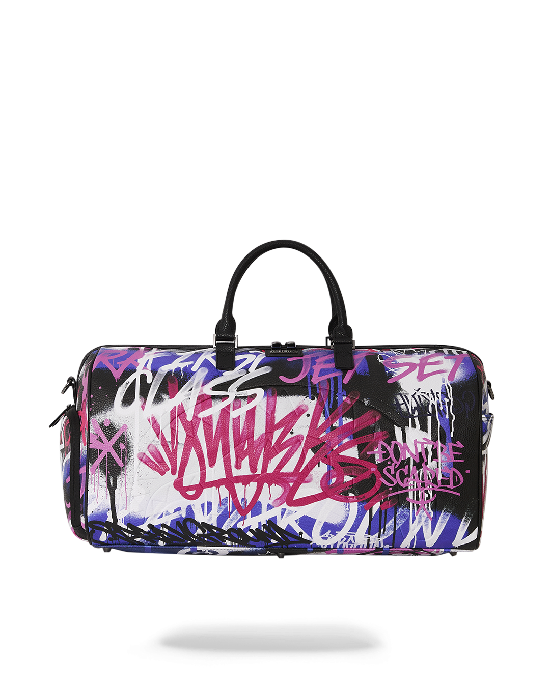 Sprayground leather duffle bag in travel setting with gold zippers.
