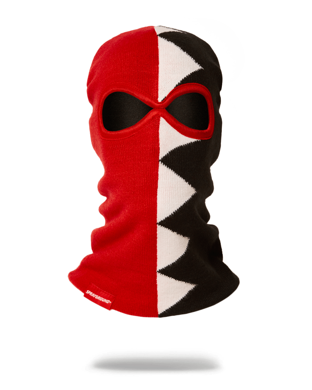 Shark ski mask worn by a skier in snowy mountains, showcasing its winter performance.