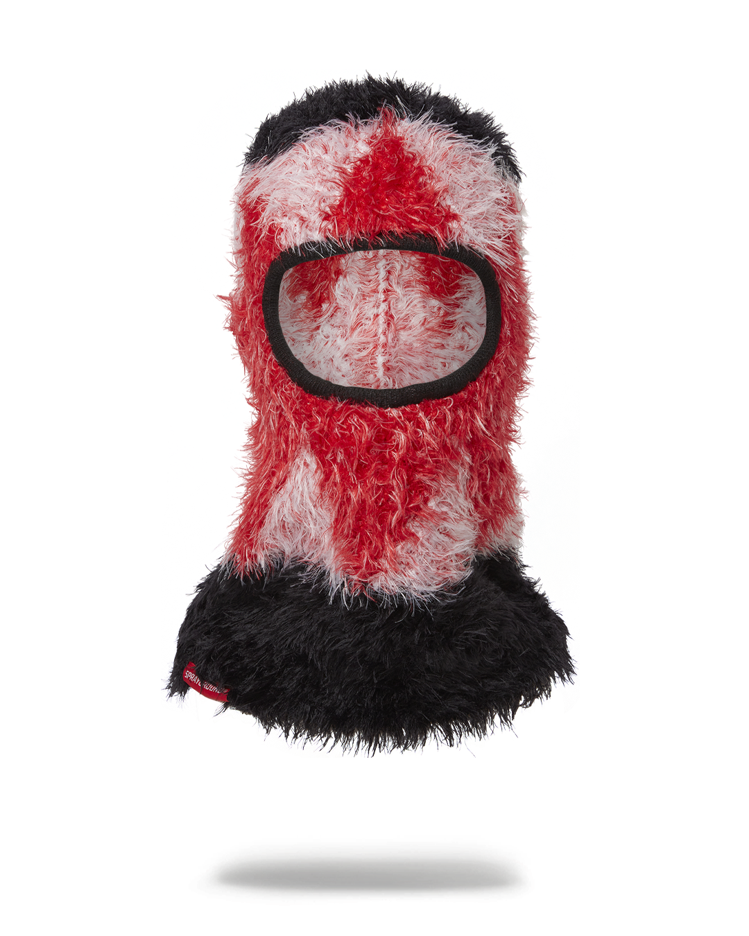 Man wearing a gray knitted ski mask while hiking in snow-covered woods