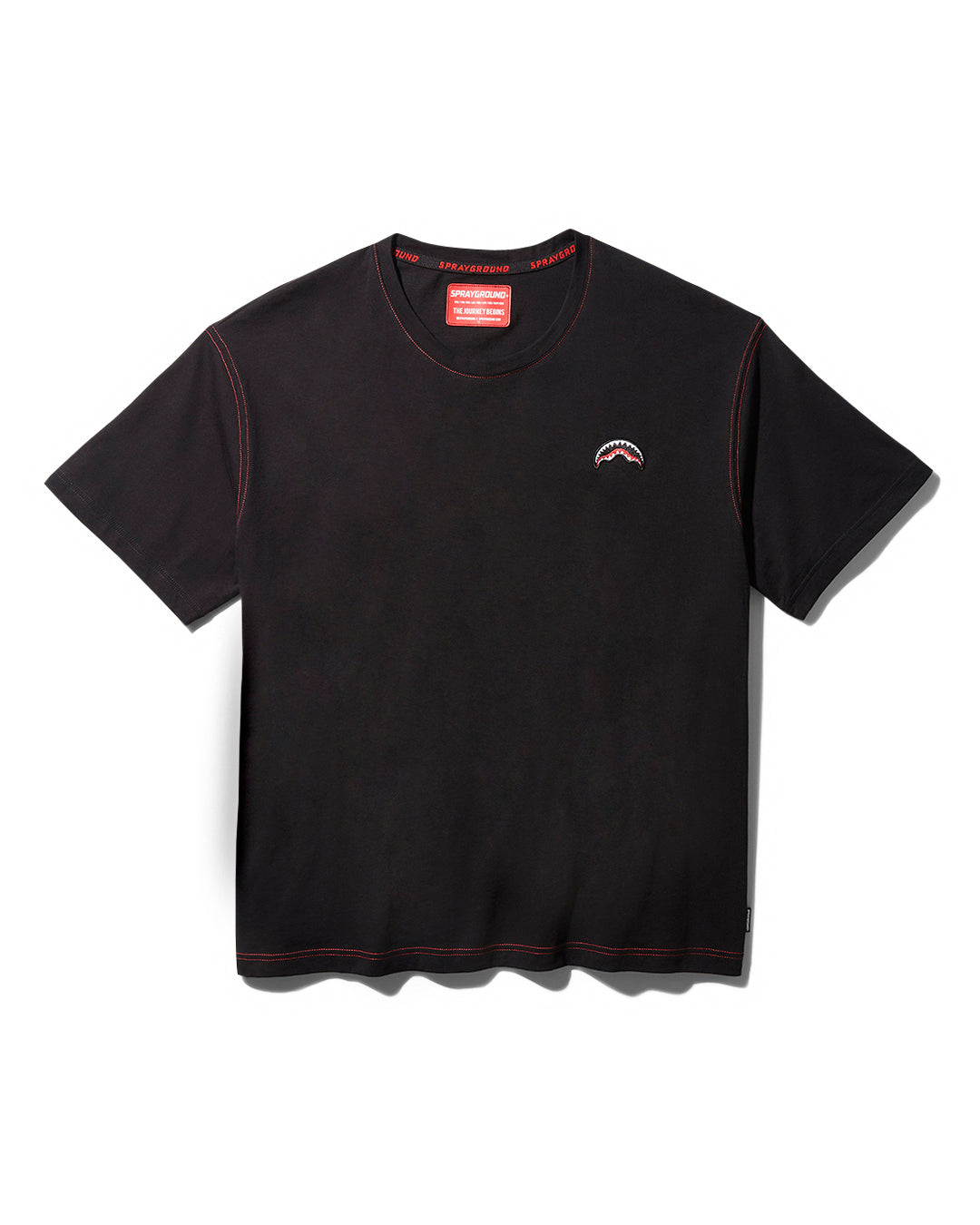 Close-up of embroidered sharkmouth logo on black t-shirt