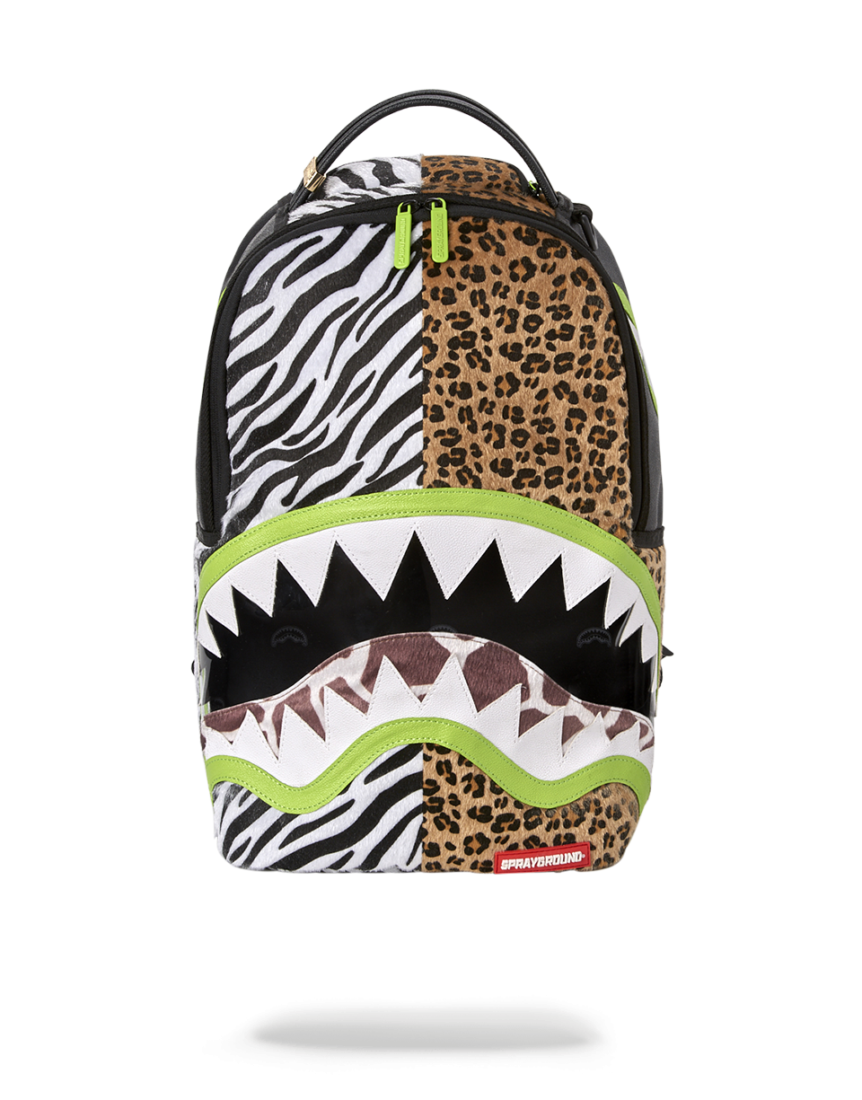 Front view of the Safari Luxe travel backpack showing cutout detailing and green zippers