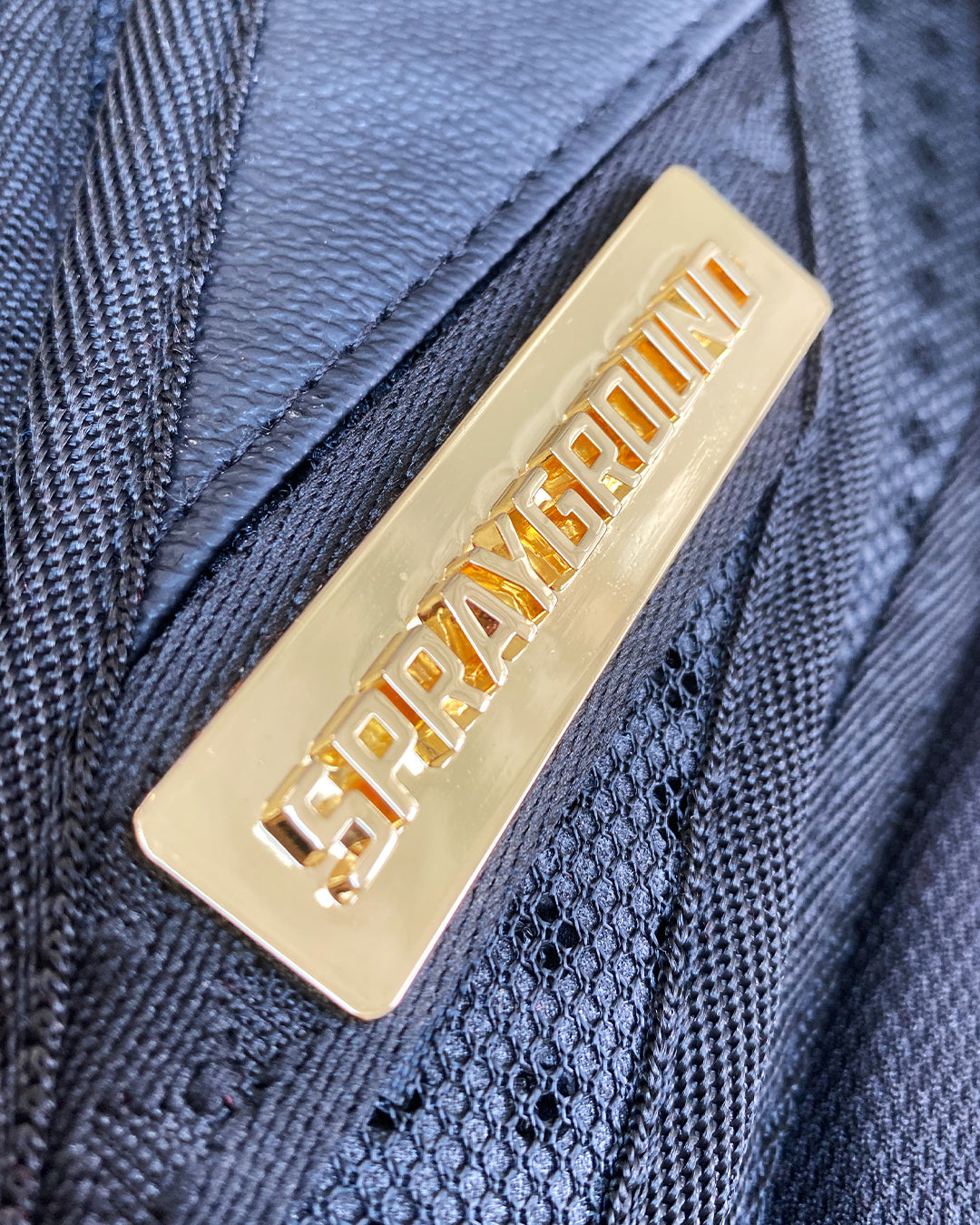 Side view showing zippered pockets and ergonomic padded straps